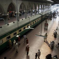 In this Saturday, June 8, 2013 photo, passengers board a train at the Lahore railway station, in Pakistan. Most of Pakistan's planes are more than 25 years old and not in the best of shape, its staff is bloated, and every flight is probably costing the state money instead of adding to its bottom line, with the carrier losing some $300 million a year. That’s emblematic of the problems with Pakistan’s state-owned enterprises, underlining how difficult it will be for Prime Minister Nawaz Sharif to carry out a key promise for rebuilding the economy _ rescuing, reforming and possibly privatizing a slew of state companies. 