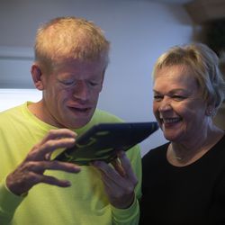 Celestia Cragun helps her son Robbie, 40, with his iPad at their home in Cottonwood Heights, Utah, on Saturday, June 8, 2019. Cragun's husband passed away in February of this year and she has been taking care of Robbie by herself ever since. "I've been doing most of the physical things involved in caring for Robbie for many years."
