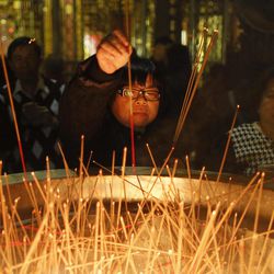 In this  Wednesday, Feb. 18, 2015, photo, devotees offer incense sticks on the eve of the Chinese new year at the Lungshan Temple in Taipei, Taiwan. According to the Lunar calendar, Chinese will celebrate the Lunar New Year on Feb. 19 this year which marks the Year of the Sheep. 