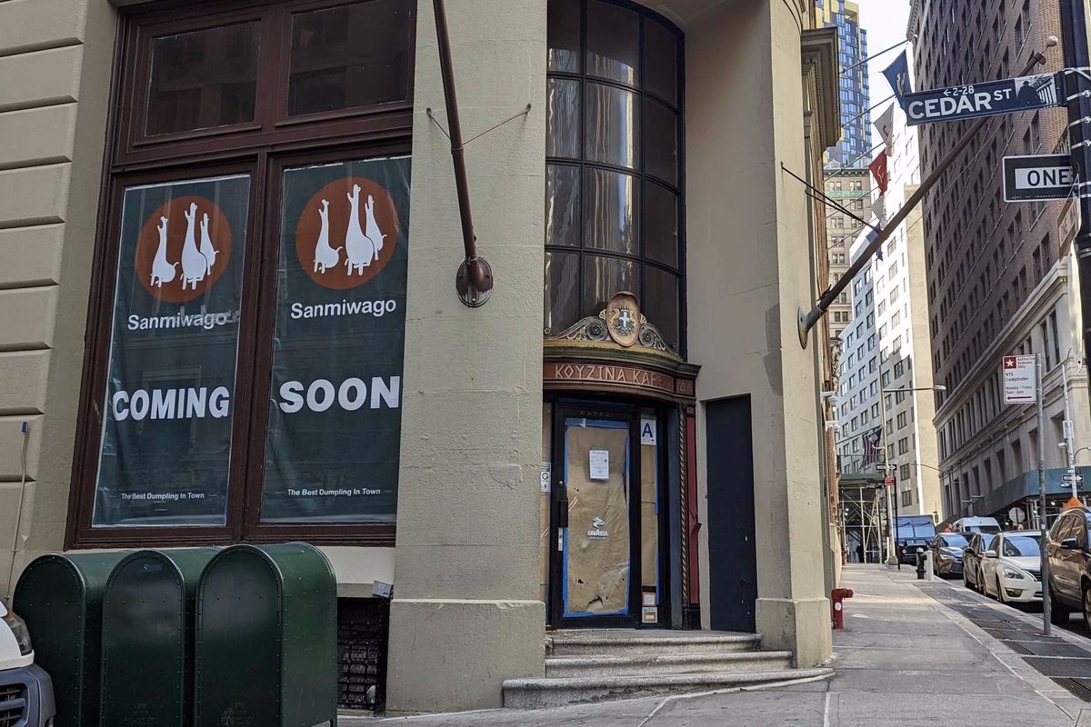 A restaurant, Sanmiwago, has “coming soon” signs on a building in the Financial District.