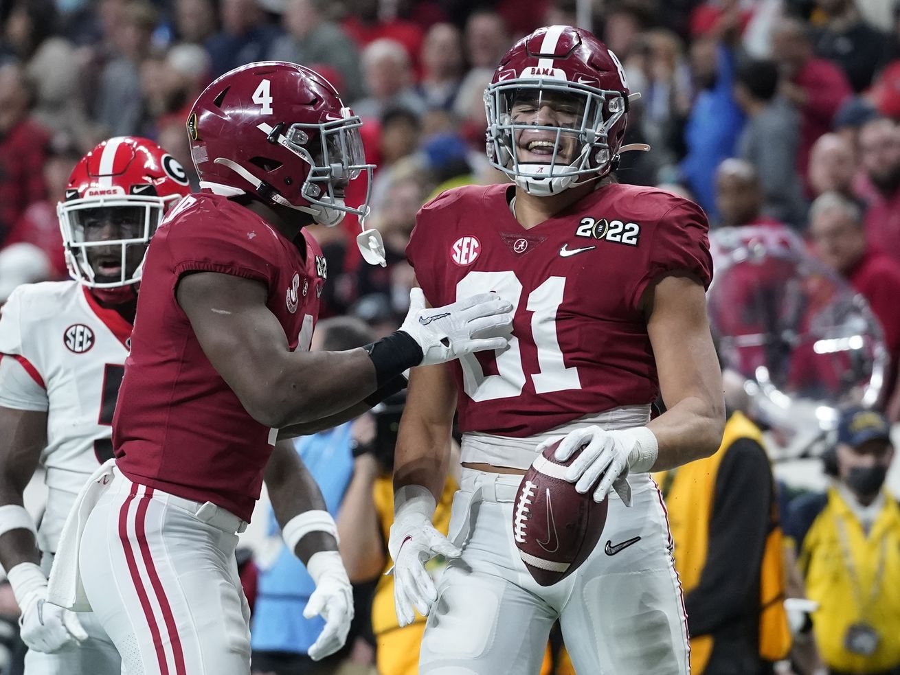 Alabama’s Cameron Latu, wearing red, is congratulated by Brian Robinson Jr. after a long reception 