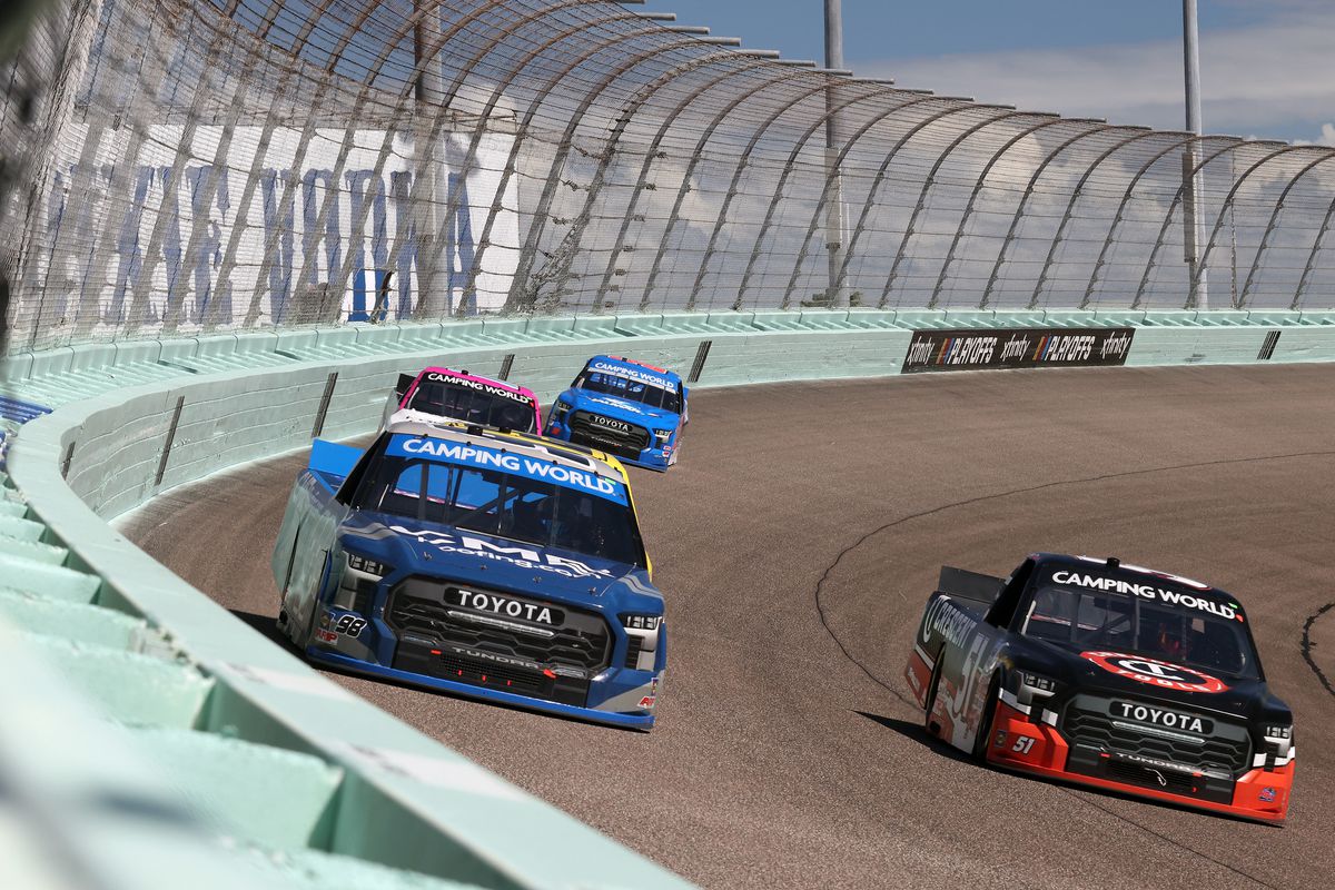 Christian Eckes, driver of the #98 CMR Construction &amp; Roofing Toyota, and Corey Heim, driver of the #51 Crescent Tools Toyota, race during the NASCAR Camping World Truck Series Baptist Health 200 at Homestead-Miami Speedway on October 22, 2022 in Homestead, Florida.