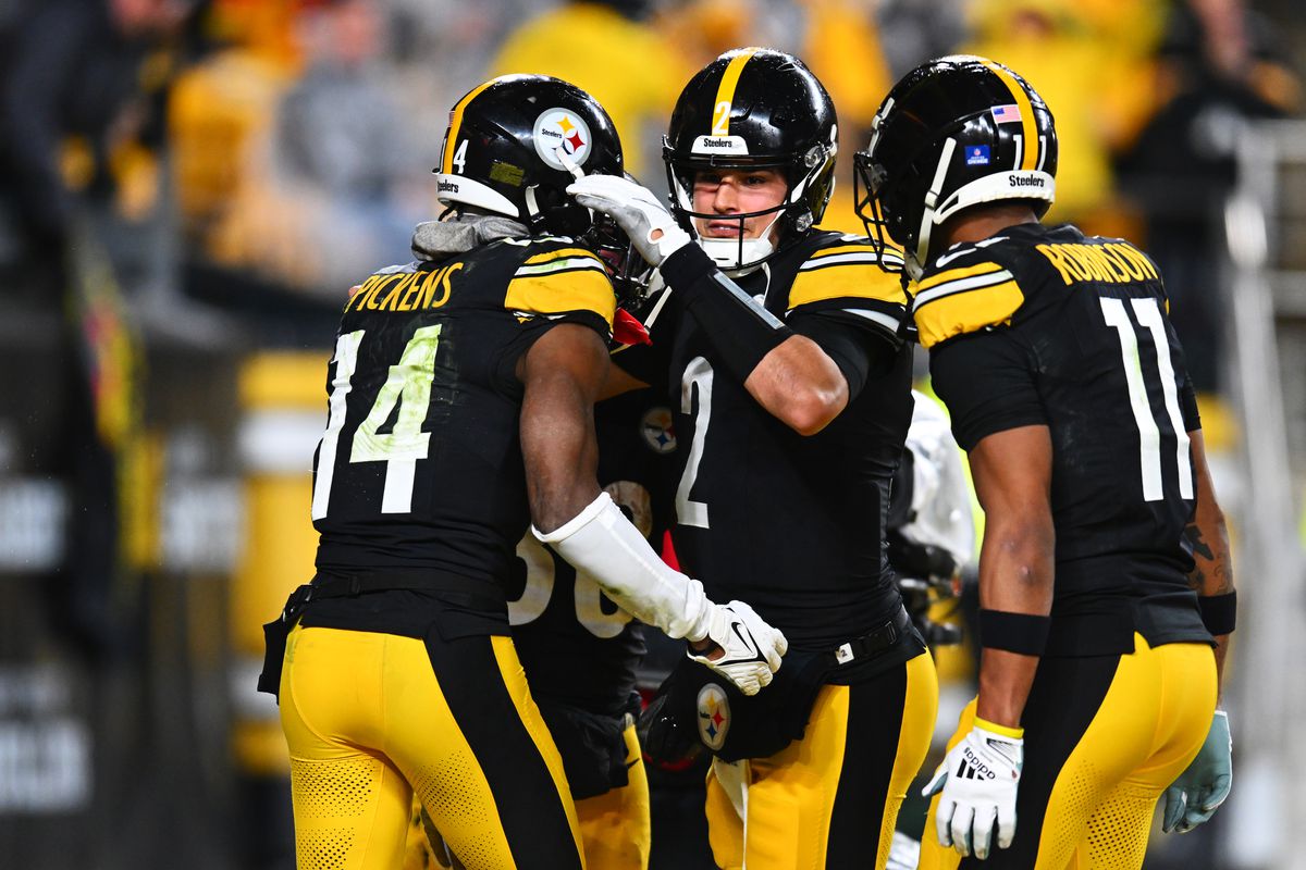 George Pickens #14 of the Pittsburgh Steelers celebrates after scoring a touchdown with his teammates Mason Rudolph #2 and Allen Robinson II #11 during the third quarter of a game against the Cincinnati Bengals at Acrisure Stadium on December 23, 2023 in Pittsburgh, Pennsylvania.