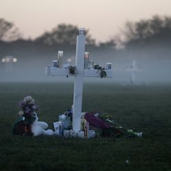 An early morning fog rises where 17 memorial crosses were placed, for the 17 deceased students and faculty from the Wednesday shooting at Marjory Stoneman Douglas High School, in Parkland, Fla., Saturday, Feb. 17, 2018. As families began burying their dead, authorities questioned whether they could have prevented the attack at the high school where a gunman, Nikolas Cruz, took several lives. (AP Photo/Gerald Herbert)