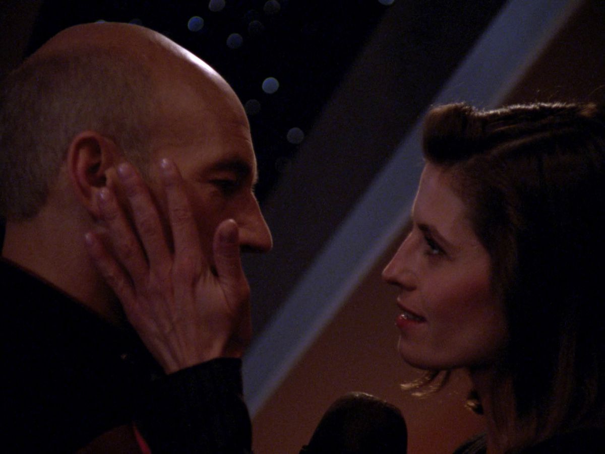 Picard letting his face be held by his vacation fling, Vash