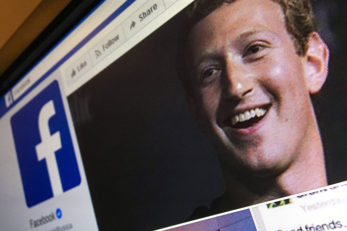 Facebook CEO Mark Zuckerberg on a computer screen with the Facebook logo.