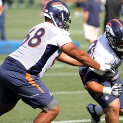 Broncos tackle Ryan Harris extends his arms to block out rookie G Andre Davis
