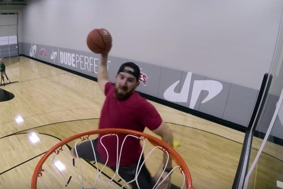 Dude Perfect's Tyler Toney goes up for a trampoline alley-oop.