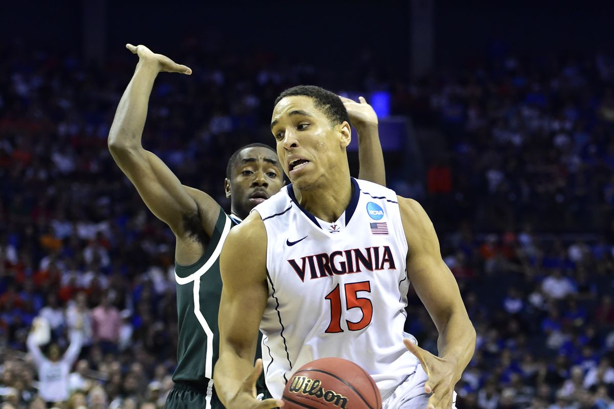 Mar 22, 2015; Charlotte, NC, USA; Virginia Cavaliers guard Malcolm Brogdon (15) looses control of the ball against Michigan State Spartans guard Lourawls Nairn Jr. (11) during the second half in the third round of the 2015 NCAA Tournament.