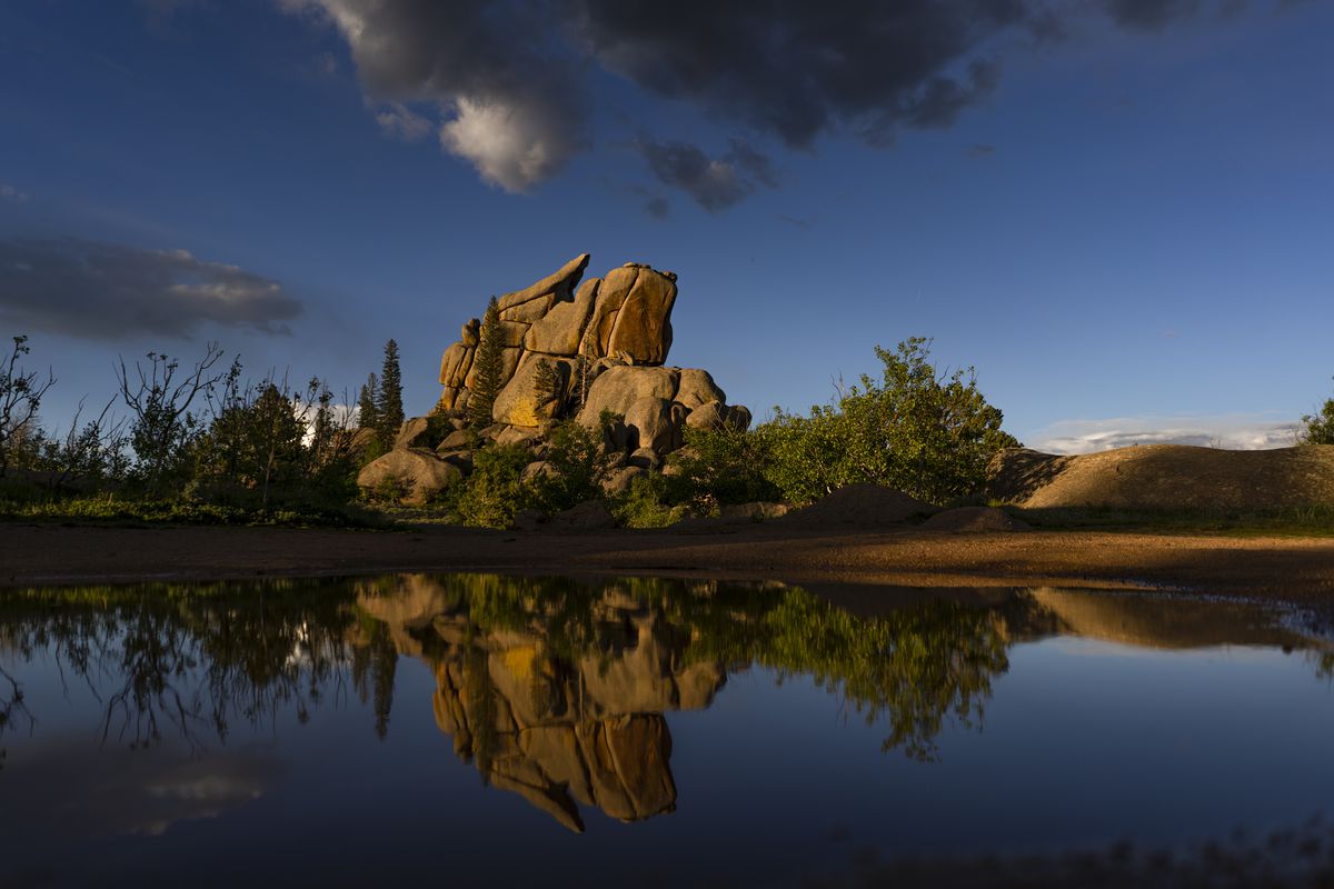 Rock formations are reflected in water from a recent rain storm outside at Vedauwoo in the Medicine Bow-Routt National Forest near Cheyenne, Wyoming on June 24, 2019.
