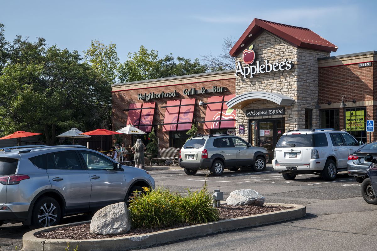 People enjoy the outdoor patio at Applebee’s restaurant after being able to open under restrictions during the coronavirus pandemic, Roseville, Minnesota.