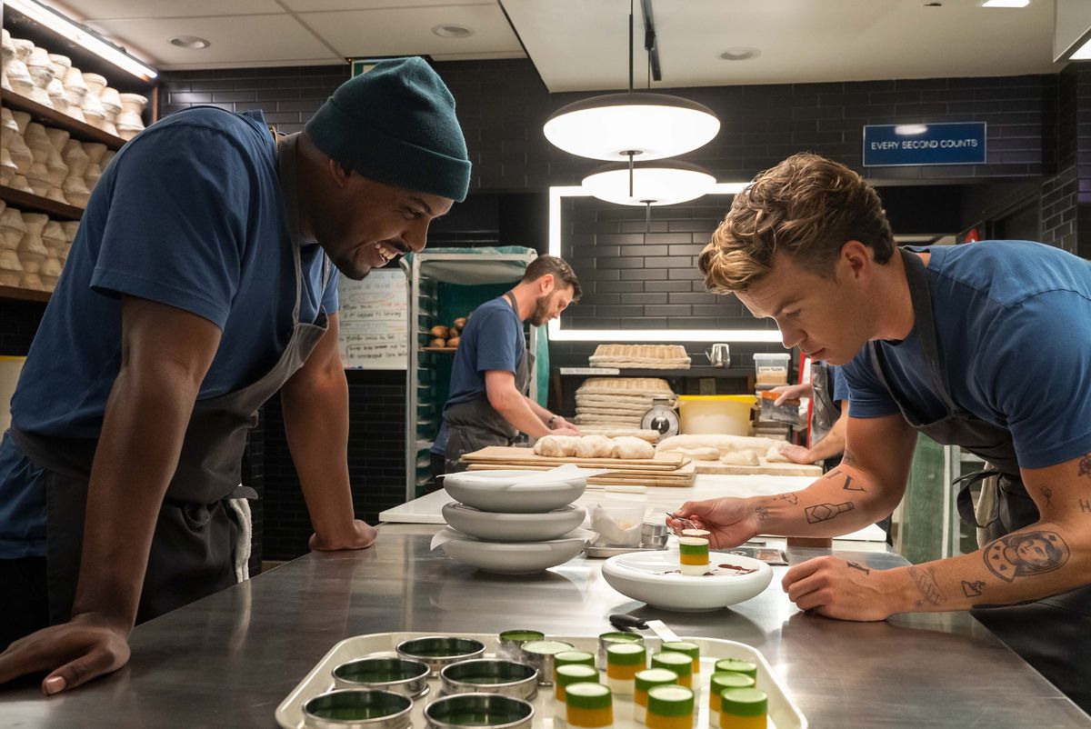Lionel Boyce as Marcus watches Will Poulter as Luca tweeze something onto food