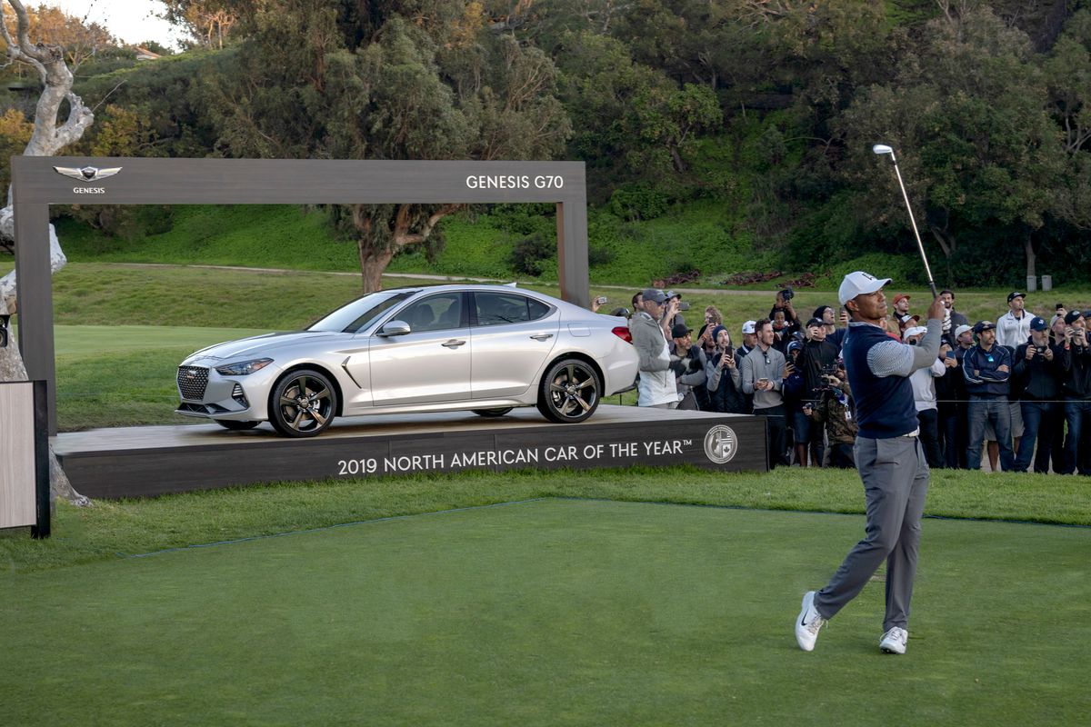 Tiger Woods taking a swing on the green at the 2019 Genesis Open.
