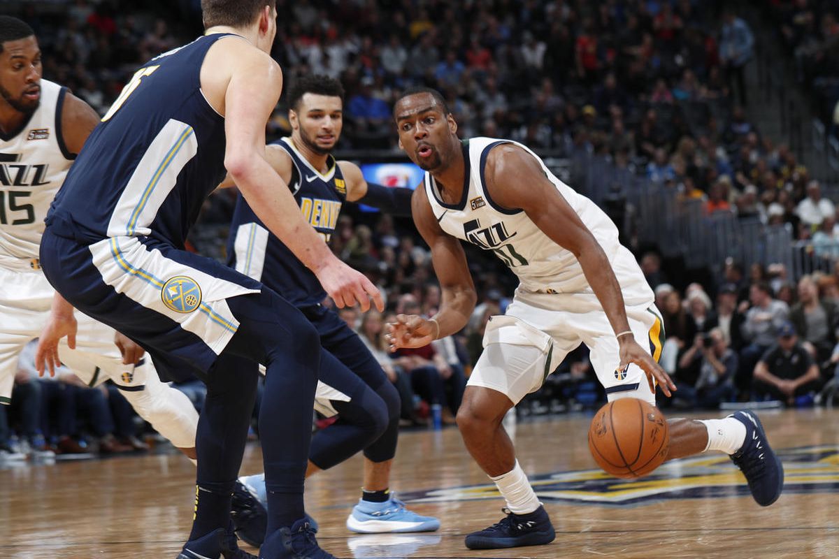 Utah Jazz guard Alec Burks looks to navigate the lane on the way to the net as Denver Nuggets center Nikola Jokic, front, of Serbia, and guard Jamal Murray defend during the second half of an NBA basketball game Friday, Jan. 5, 2018, in Denver. The Nugget