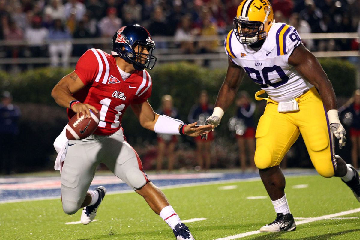 OXFORD, MS - NOVEMBER 19: Barry Brunetti #11 of the Ole Miss Rebels scrambles with the ball against Michael Brockers #90 of the LSU Tigers on November 19, 2011 at Vaught-Hemingway Stadium in Oxford, Mississippi.  (Photo by Joe Murphy/Getty Images)