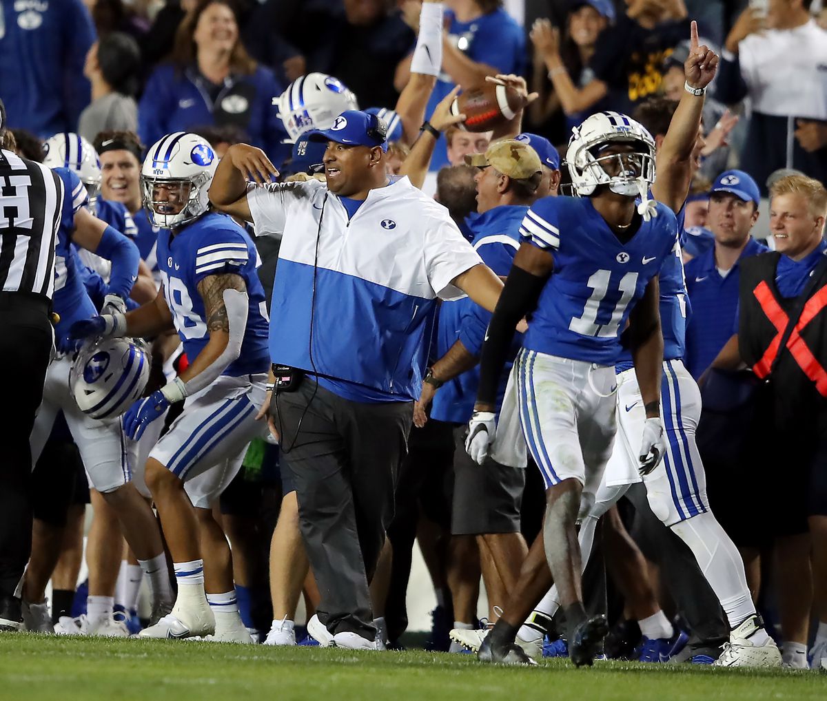 BYU Cougars head coach Kalani Sitake and players begin to celebrate a a win over Utah on Sept. 11, 2021. BYU won 26-17.