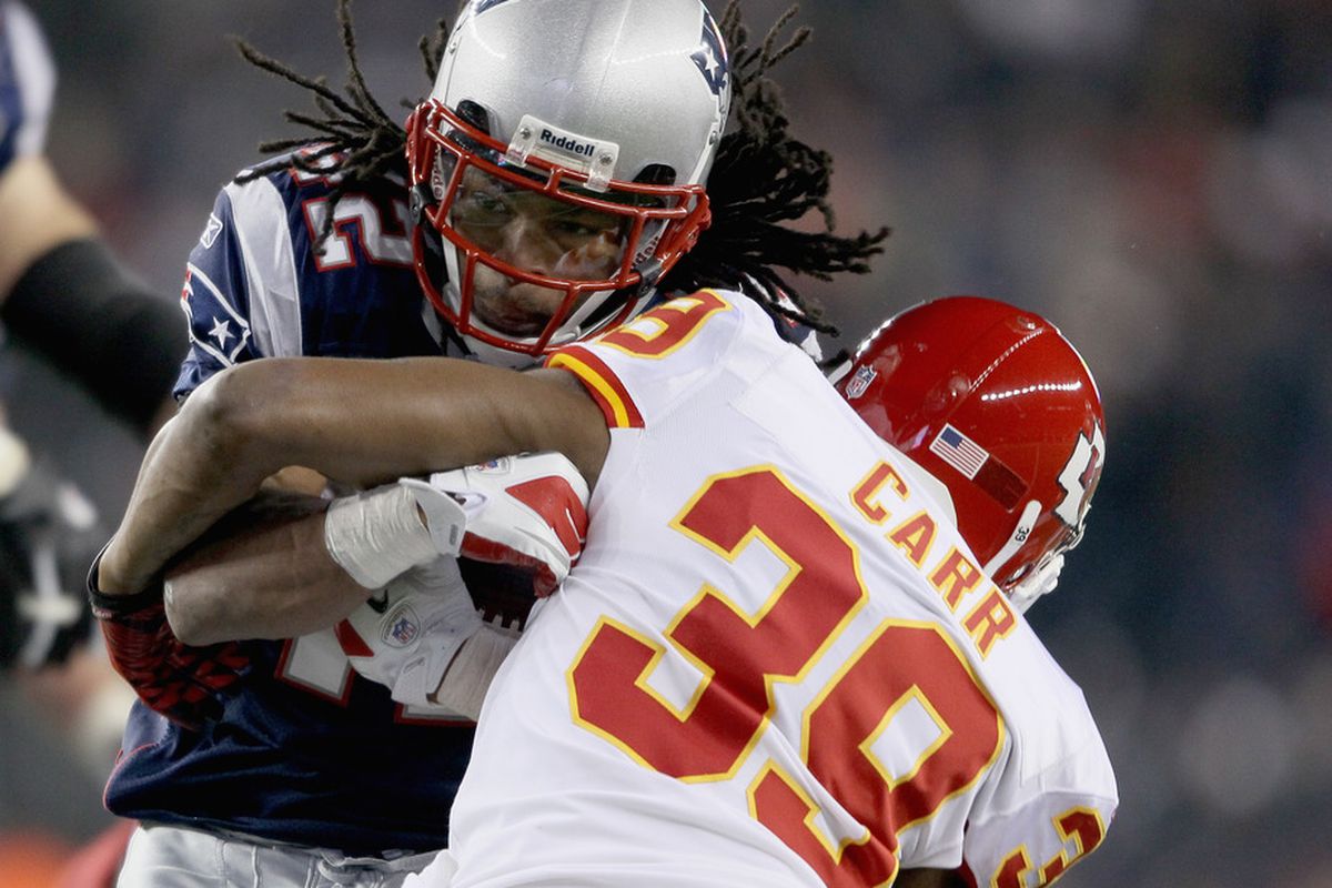 FOXBORO, MA - NOVEMBER 21:   BenJarvus Green-Ellis #42 of the New England Patriots is tackled by  Brandon Carr #39 of the Kansas City Chiefs on November 21, 2011 at Gillette Stadium in Foxboro, Massachusetts.  (Photo by Elsa/Getty Images)