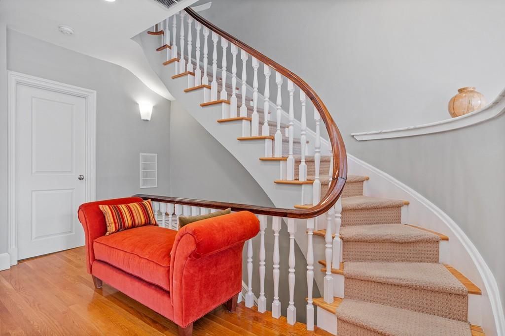 A staircase landing with a couch. 