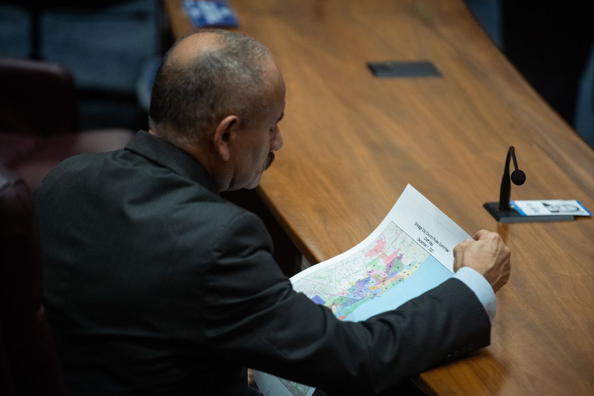 Ald. Ariel Reboyras (30th) looks over the draft ward map distributed at the Chicago City Council meeting on Wednesday, Dec. 1, 2021.