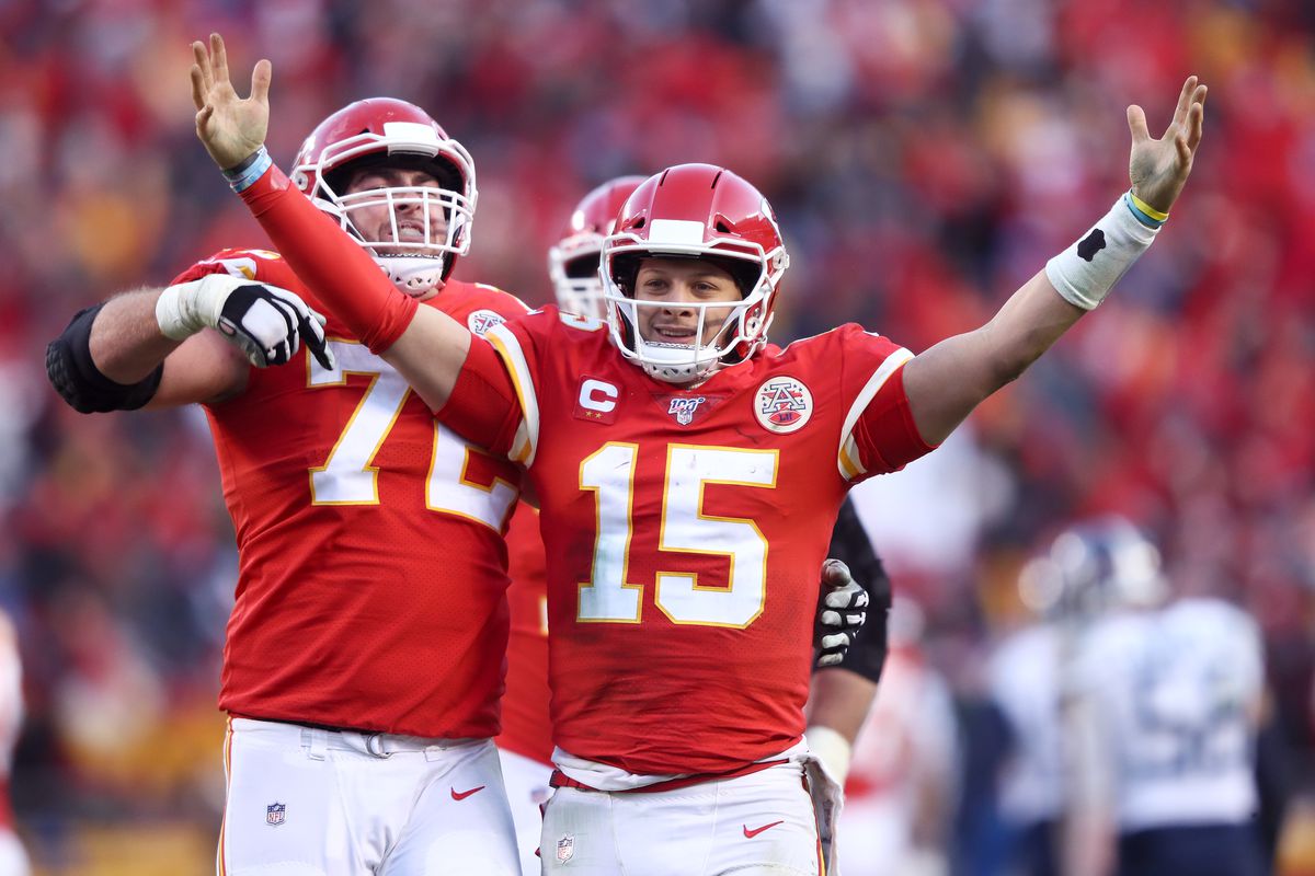 Patrick Mahomes of the Kansas City Chiefs reacts with teammate Eric Fisher after a fourth quarter touchdown pass against the Tennessee Titans in the AFC Championship Game at Arrowhead Stadium on January 19, 2020 in Kansas City, Missouri.