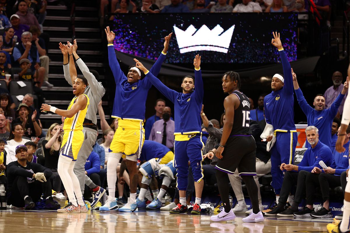  The Golden State Warriors bench reacts after they made a three point basket against the Sacramento Kings in the first half at Golden 1 Center on April 03, 2022 in Sacramento, California.