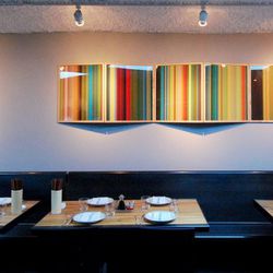 Colored glass artwork adds punch in the mezzanine dining area.