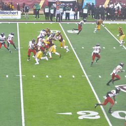 NIU quarterback Ross Bowers (12) drops back to pass as receivers go into their routes.