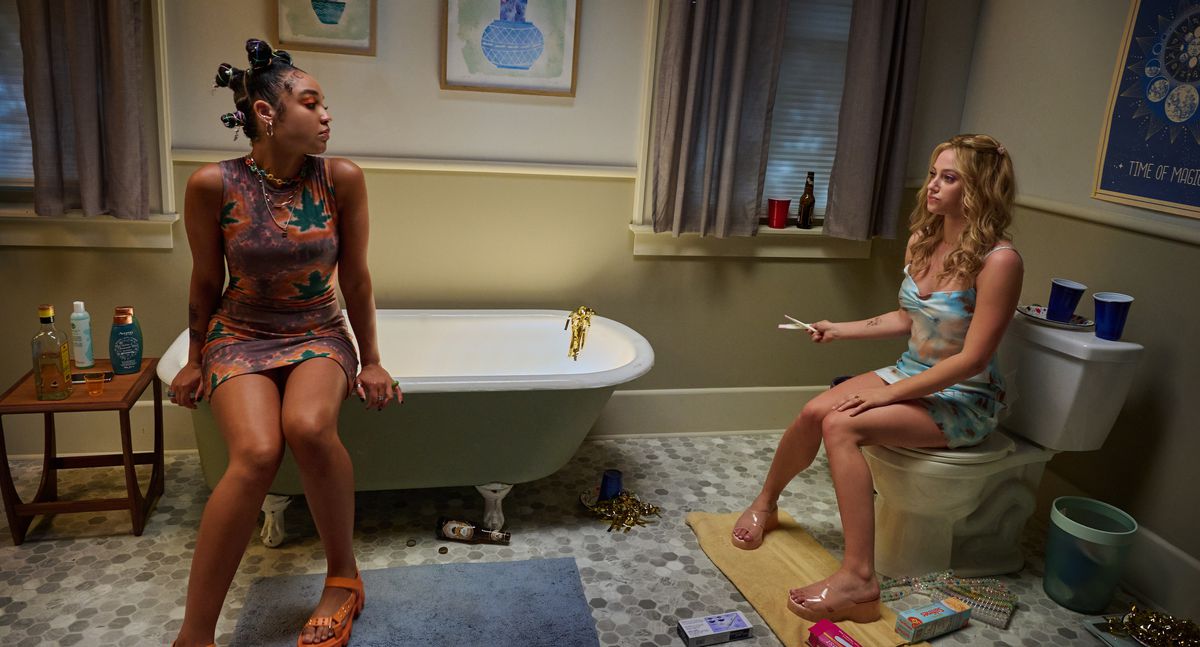 Cara (Aisha Dee) and Natalie (Lili Reinhart) sit in the bathroom together in Look Both Ways.