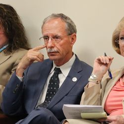 Salt Lake County Recorder Gary Ott sits with Chief Deputy Recorder Julie Dole, left, and governmental affairs liaison Karmen Sanone in the county council meeting as members meet and vote on a new nepotism policy during their meeting in Salt Lake City on Tuesday, April 26, 2016.