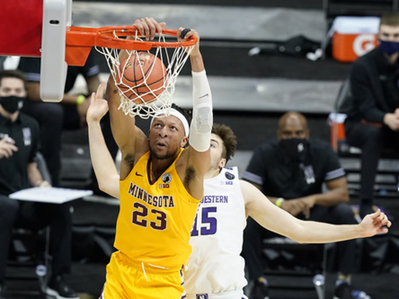 Minnesota’s Brandon Johnson (23) dunks against Northwestern’s Ryan Young (15) during the first half of an NCAA college basketball game at the Big Ten Conference tournament.