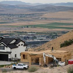A residential development is seen with the Adobe building in the background in Lehi on Monday, July 17, 2017.