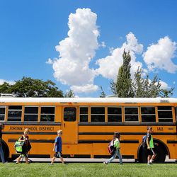 Students board buses at Oquirrh Elementary in West Jordan on Friday, Aug. 25, 2017. The Utah Department of Transportation is providing temporary bus service to students in neighborhoods affected by the reconstruction of a pedestrian bridge on Bangerter Highway.