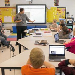 In this photo taken Feb. 12, 2015, sixth grade teacher Carrie Young guides her students through an exercise on their laptops as practice for the the Common Core State Standards Test in her classroom at Morgan Elementary School South in Stockport, Ohio. 