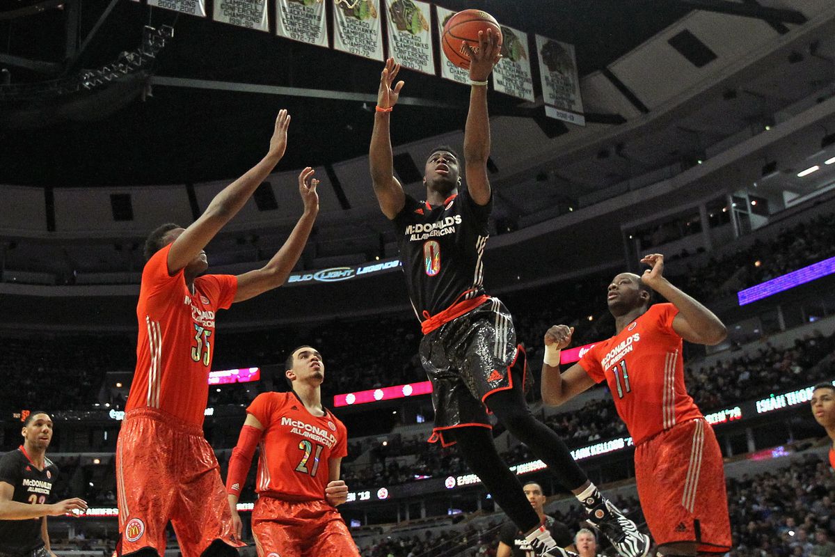 CHICAGO, IL - APRIL 02: Emmanuel Mudiay #0 of the west team goes up for a shot between (L-R) Myles Turner #35, Tyus Jones #21 and Cliff Alexander #11 of the east team during the 2014 McDonald's All American Game