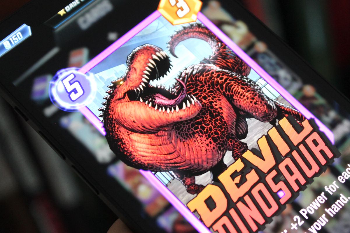 A photo of the Devil Dinosaur card in Marvel Snap on an iPhone