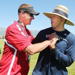 Wisconsin coach Gary Andersen clowns around with BYU grad assistant Jason Kaufusi as players work out during All Poly Camp in Layton Thursday, June 20, 2013.