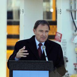 Utah Gov. Gary Herbert announces a U-CAIR clean air initiative in Salt Lake City Tuesday, Jan. 31, 2012. The governor is surrounded by alternative fuel source vehicles during the news conference.