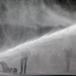 Turkish riot police spray water cannon at demonstrators who remained defiant after authorities evicted activists from an Istanbul park, making clear they are taking a hardline against attempts to rekindle protests that have shaken the country, in city's main Kizilay Square in Ankara, Turkey, Sunday, June 16, 2013.
