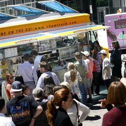 Customers wait in line at the Chow Truck at Gallivan Center in Salt Lake City on Thursday, June 6, 2013.