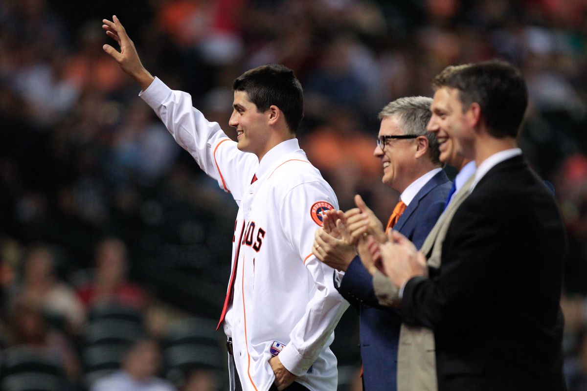 Astros Scouting Director Mike Elias (second to right) applauds alongside General Manager Jeff Luhnow (second to left) as Mark Appel (far left) is introduced to fans as the first pick of the 2013 MLB Draft.