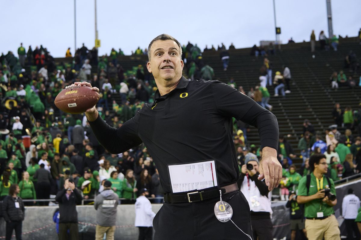 Oregon Ducks head coach Mario Cristobal throws a football to his son s after a game against the Oregon State Beavers at Autzen Stadium.