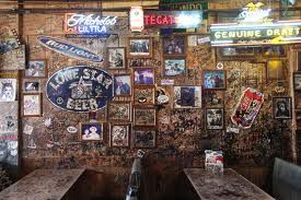 An interior shot of the graffiti and stickered walls of Adair’s Saloon.
