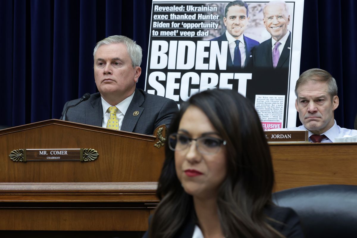 House Oversight Committee Chair Rep. James Comer (R-KY) leading a committee meeting with Rep. Lauren Boebert (R-CO) in the foreground and a poster of a New York Post front page story about Hunter Biden’s emails and Rep. Jim Jordan (R-OH) in the background.