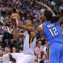 Utah Jazz guard Rodney Hood (5) tries to put up a shot over Oklahoma City Thunder center Steven Adams (12) as the Jazz and the Thunder play at Vivint Smart Home arena in Salt Lake City on Wednesday, Dec. 14, 2016.