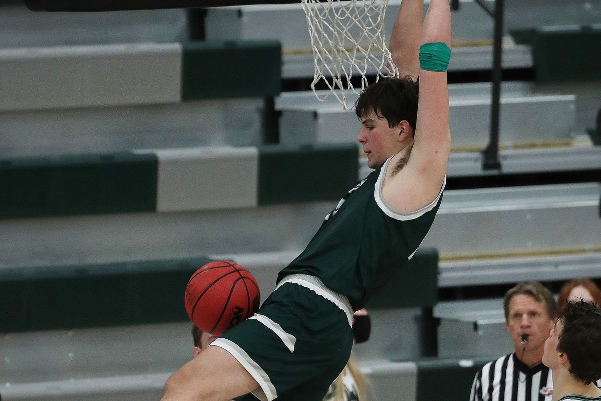 Olympus’ Jack Wistrcill (15) dunks over Hillcrest in Midvale on Friday, Feb. 5, 2021.