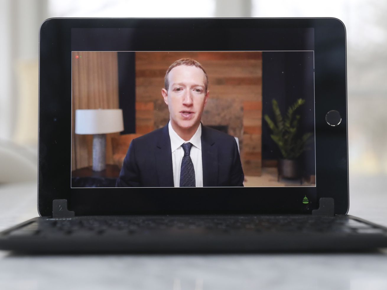 Facebook CEO Mark Zuckerberg on a laptop screen as he speaks to Congress.