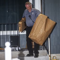 Investigators bring bags of evidence out of a home at 547 N. 1000 West in Salt Lake City as police serve a search warrant in connection to the disappearance of University of Utah student Mackenzie Lueck on Wednesday, June 26, 2019.