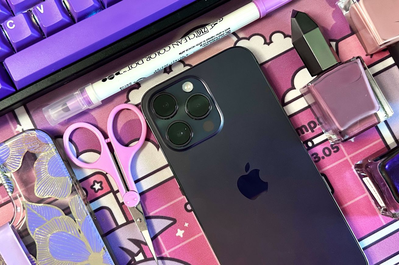 iPhone 14 Pro Max in deep purple surrounding by several objects that are objectively more purple.