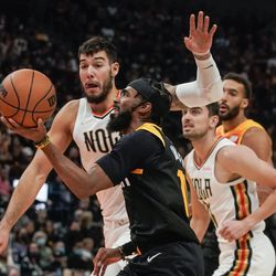 Utah Jazz guard Mike Conley, front, goes for a shot as New Orleans Pelicans center Willy Hernangomez goes for a block during an NBA game at Vivint Arena in Salt Lake City on Saturday, Nov. 27, 2021.
