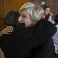 Kathy Hill, wife of University of Utah athletic director Chris Hill, receives a hug following a press conference regarding her husband's retirement after 31 years in the position at Jon M. Huntsman Center in Salt Lake City on Monday, March 26, 2018. Hill was 37 years old when he took the position in 1987.